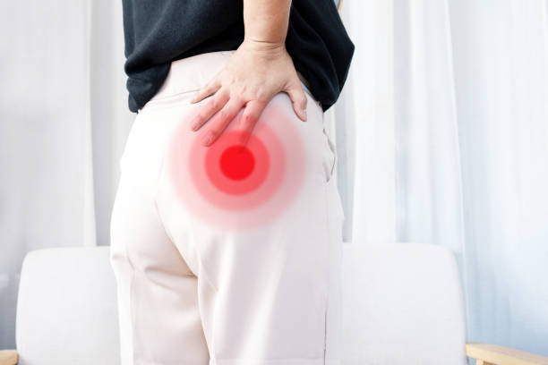 Piriformis syndrome concept with woman suffering from buttock muscle pain stock photo
