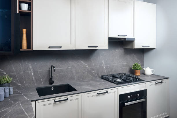 istock Interior of white and grey kitchen, horizontal, linear layout. Luxury modern fitted flat design kitchen with glass elements. 1462531025