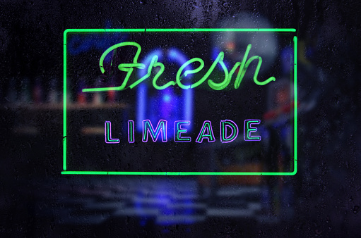 A Fresh Limeade neon Sign in Rainy Window
