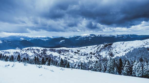 istock Mountain landscape covered with snow under a dark, cloudy sky 1462536655