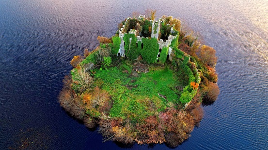 An aerial of the McDermott's Castle and a national monument surrounded by tranquil sea