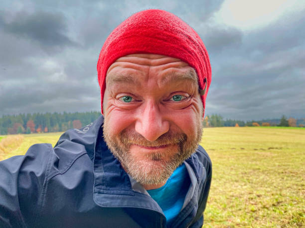 istock Running Happy Man with Red Cap in Forest 1462543779