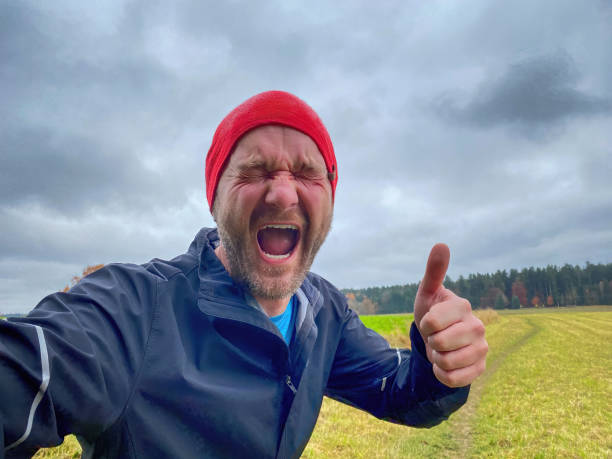 istock Running Happy Man with Red Cap in Forest 1462543791