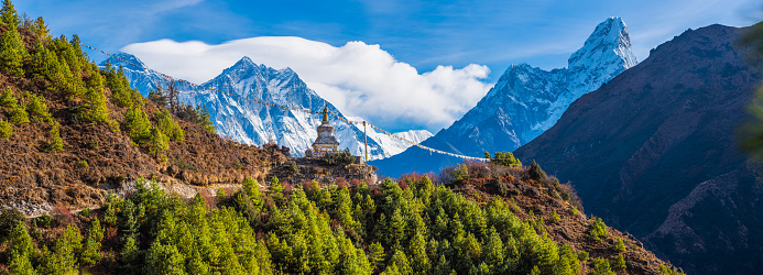 Mt. Everest (8848m), Nuptse (7861m), Lhotse (8516m) and Ama Dablam (6812m) overlooking a Buddhist Stupa and Prayer Flags high in the Khumbu Himalayan mountain wilderness of the Sagarmatha National Park, Nepal.
