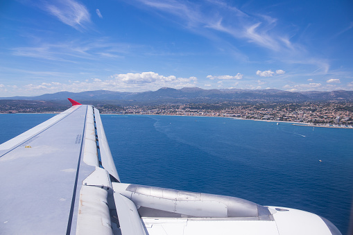 Wing view of arriving airplane in Nice, France