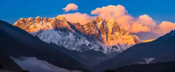 Mt. Everest, Nuptse and Lhotse glowing in the golden light of sunset guarding the Khumbu valley high in the Himalayan mountains of Nepal.
