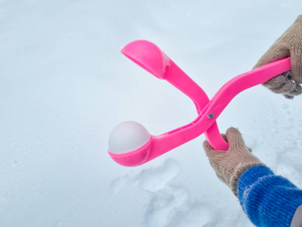 istock pink snowball maker make balls out of snow. 1462546450