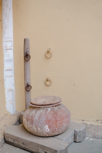 A vertical shot of a vintage clay pot on a palet