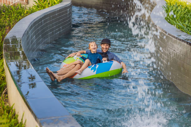 istock Father and son on a water slide in the water park 1462555347