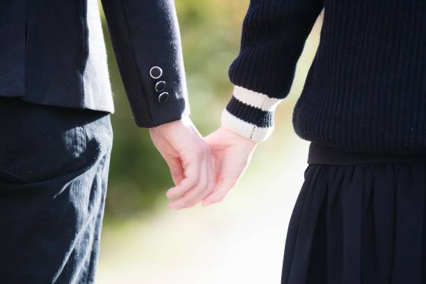 istock Back view of a couple in uniforms holding hands 1462556701