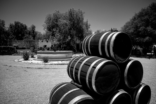 A black and white shot of a barrel pyramid as a decoration in a park
