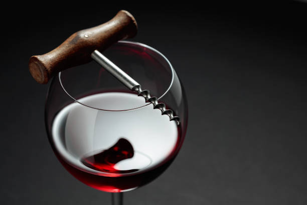 istock Glass of red wine and corkscrew. 1462558874