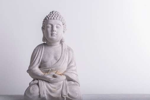 Buddha figure with horizontal white background, religion objects