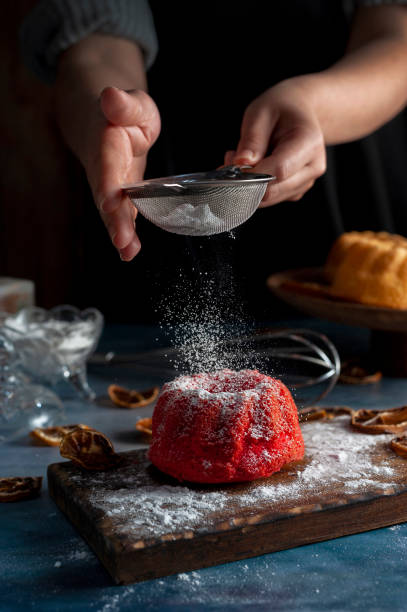 istock Caucasian hands sprinkling powder on a cake 1462562501