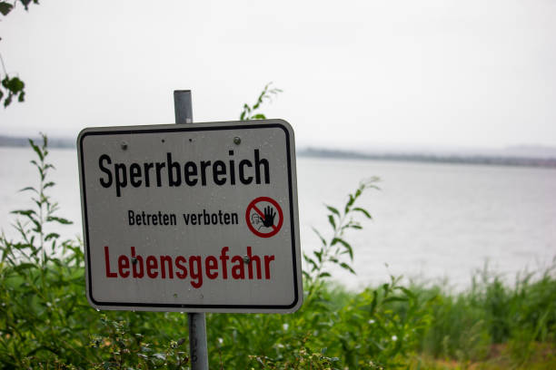istock Sign with risk of death message by the lake 1462563373