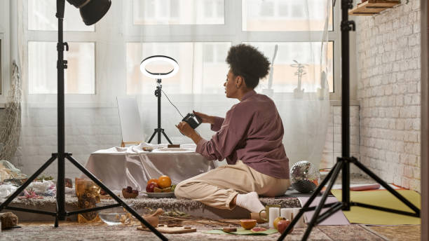istock Black girl taking photo of seashells on camera 1462563406