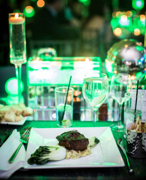 Vertical shot of a gourmet steak dish and drinks