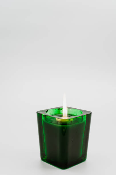 istock green scented candle in a glass on a  white background 1462564000