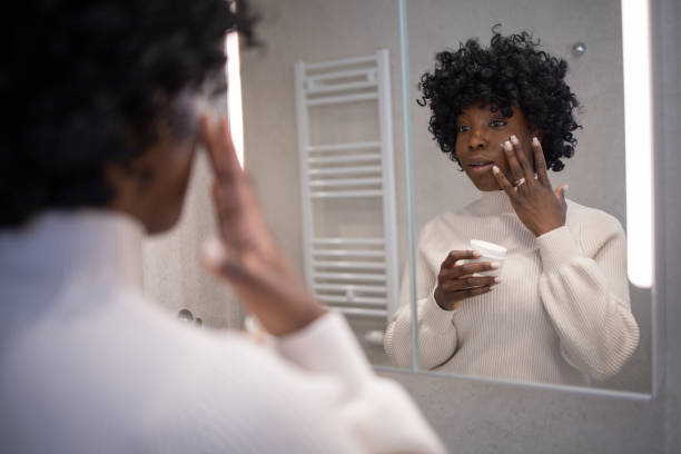 istock Woman applying moisturizer on face 1462572791