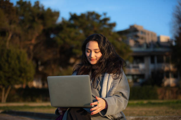istock Young student girl is studying at on the outside. 1462583427