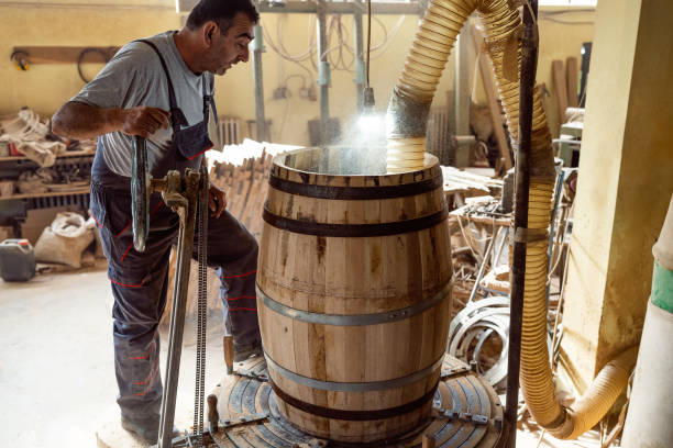 istock Cooper burning an oak barrel, so the wood can gain aroma 1462591378