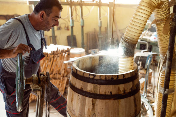 istock Cooper burning an oak barrel, so the wood can gain aroma 1462591383