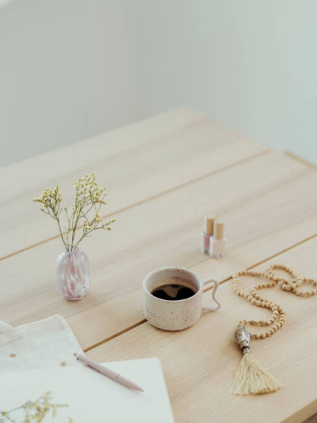 istock Modern still life at home coffee cup note book zen buddha necklace and pen on table 1462591920