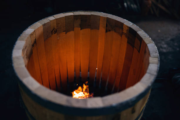 Close-up of an oak barrel burning, to gain aroma for the alcohol which will be stored in it