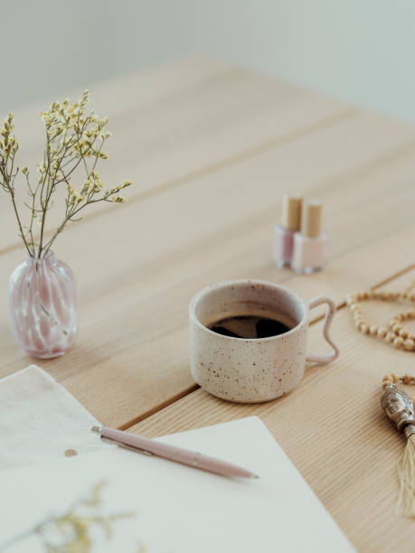istock Modern still life at home coffee cup note book zen buddha necklace and pen on table 1462592442