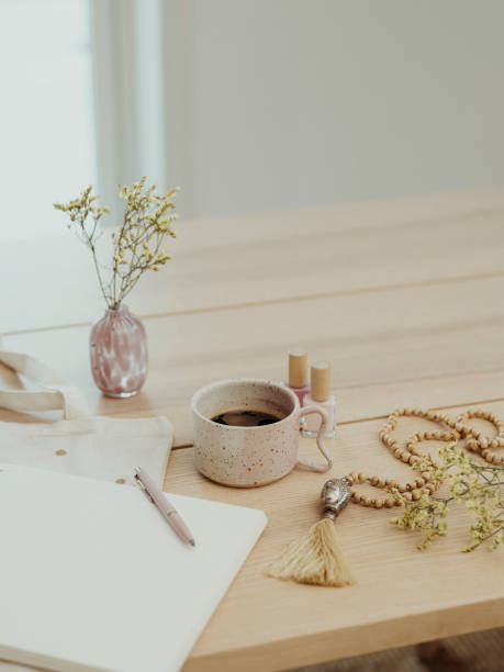 istock Modern still life at home coffee cup note book zen buddha necklace and pen on table 1462596982