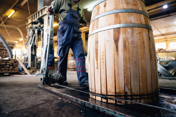 istock Cooper with machine clamps wooden steves while making barrel 1462596997