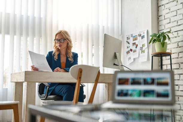 istock Business woman reading document in spacious office 1462602727