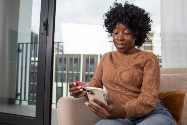 istock Cheerful  young woman doing online shopping 1462604480