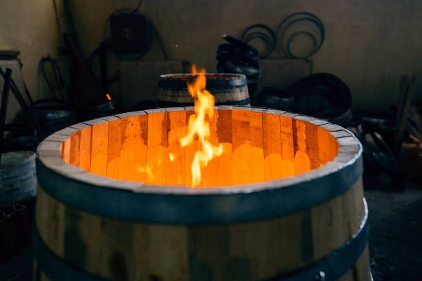 Close-up of an oak barrel burning, to gain aroma for the alcohol which will be stored in it