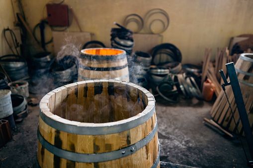 Close-up of an oak barrel burning, to gain aroma for the alcohol which will be stored in it