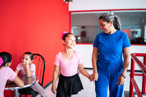 Mother arriving with daughter at a dance studio