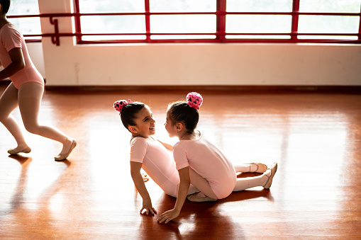 Girls ballet dancers playing at a dance studio