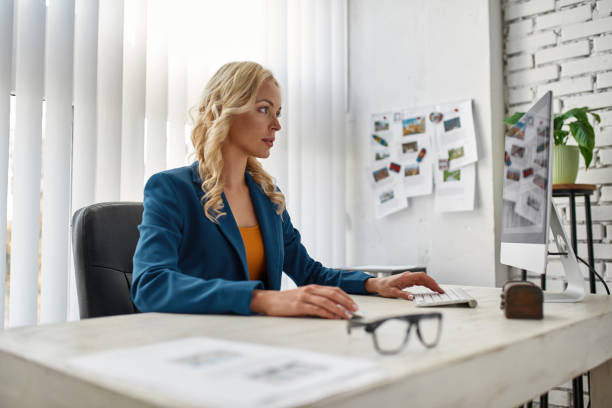 istock Female tourist agent watching hotels on computer 1462608943