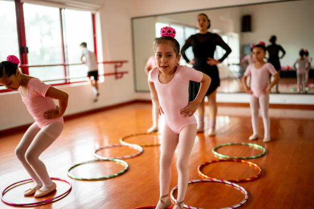 istock Portrait of ballet student doing a jumping exercise with hula hoops 1462611560