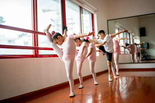 Ballet dancers stretching during a class at the dance studio