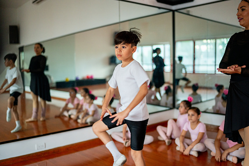 Boy spinning at ballet classes in the dance studio