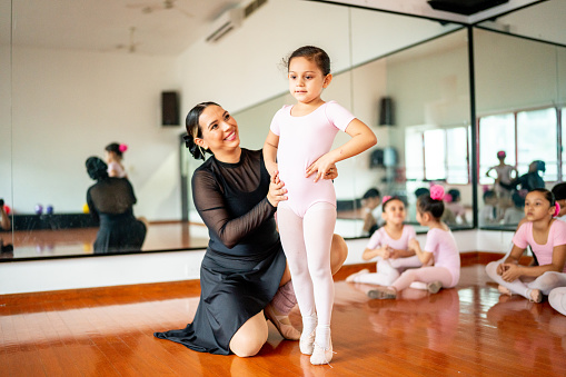 Teacher giving instruction to ballet dancer at the dance studio