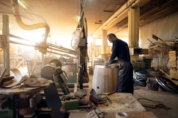 istock Barrel maker polishing the oak barrel with sander 1462613689