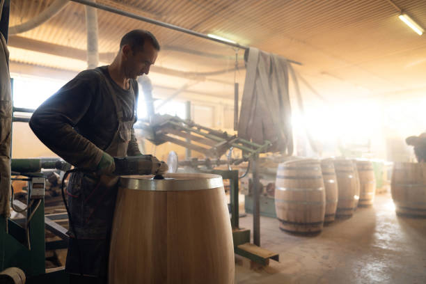 istock Barrel maker polishing the oak barrel with sander 1462613725