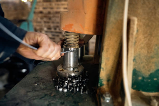 istock Male cooper, using a machine to bend metal hoop for barrel 1462613965