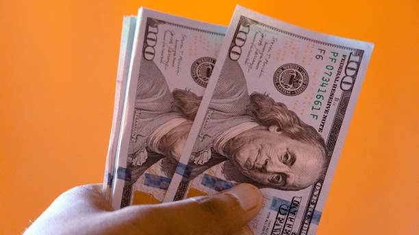 hand holding paper money stock photo
