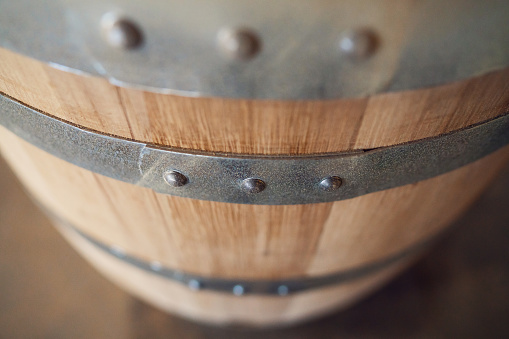 Old wooden barrel on a brown background