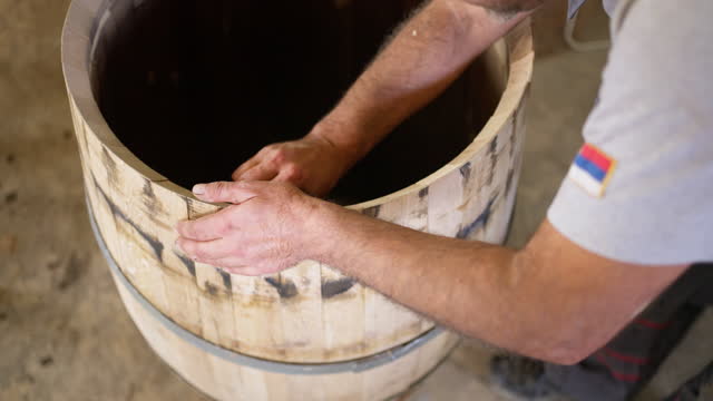 B-roll of an cooper making the oak barrel