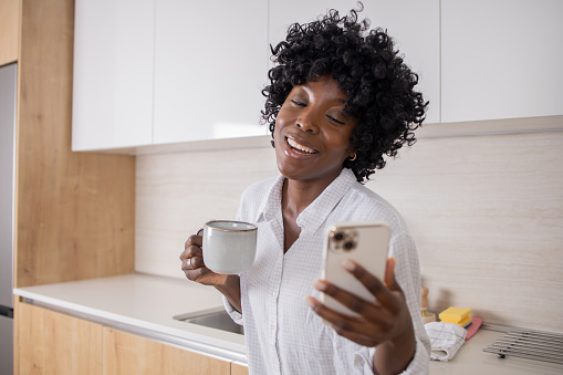 Happy young woman using her smartphone
