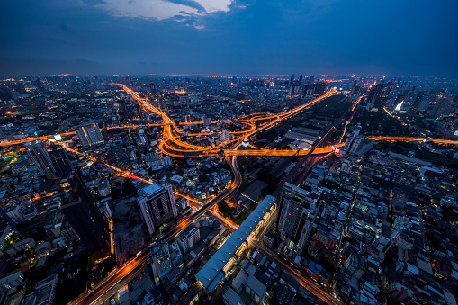 Skyline view of Bangkok business district at sunset. Bangkok Expressway and Highway top view, Thailand